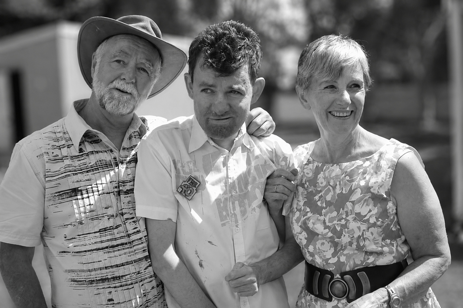 Leslie Cope, his son Adam Cope, and Peta Cope standing together outdoors.